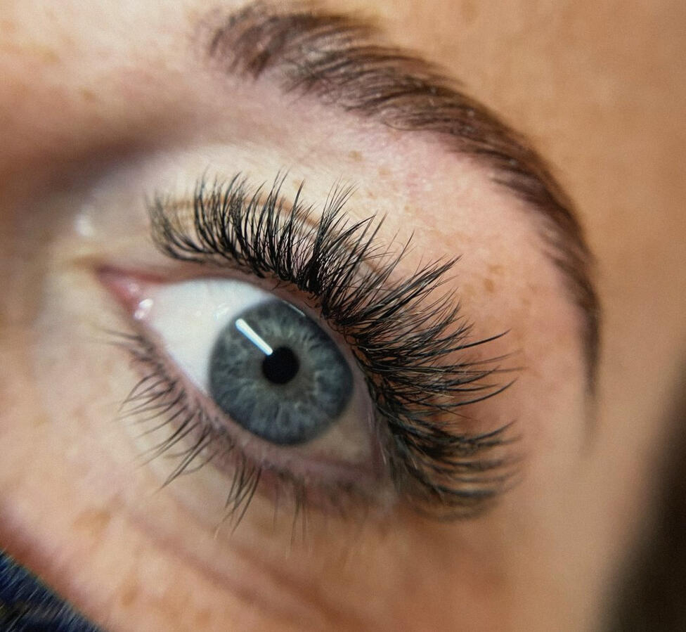 Natural lash extension set on a client